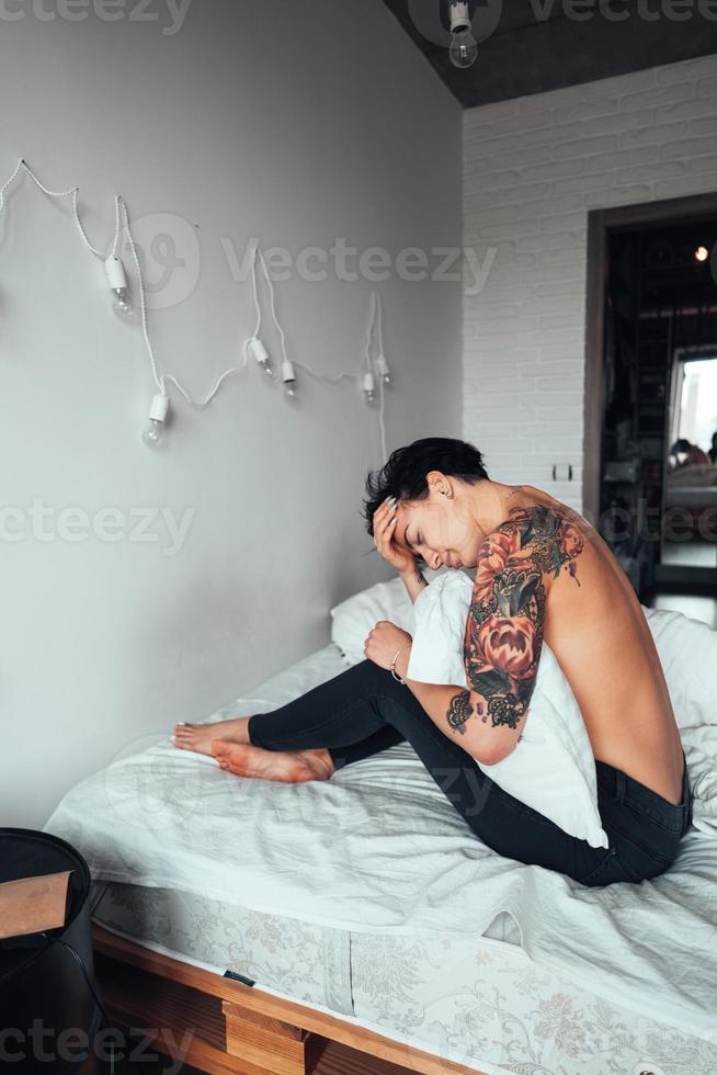 bare girl posing on the bed photo