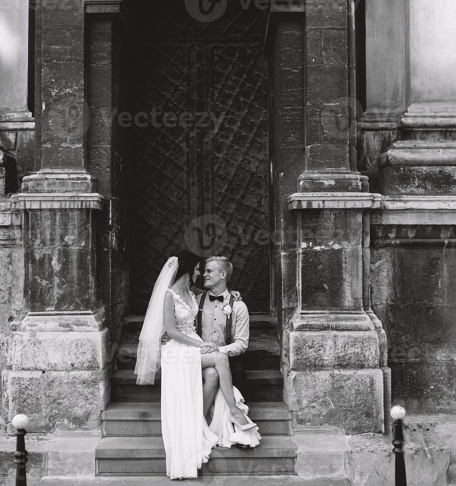 Bride sitting on lap of the bride photo