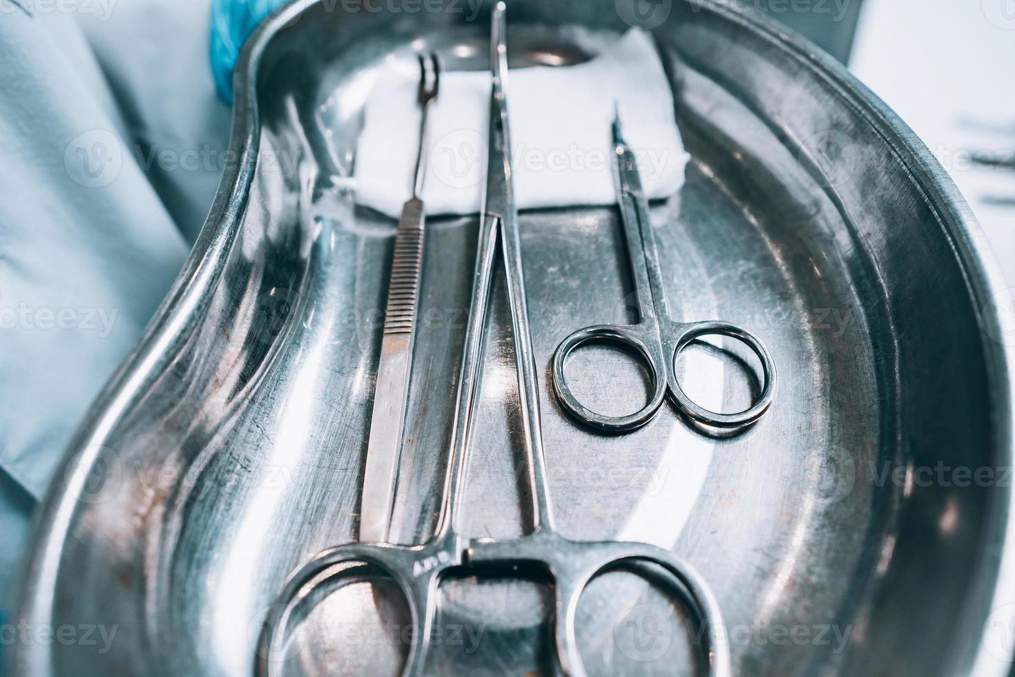 Several surgical instruments lie on a tray photo