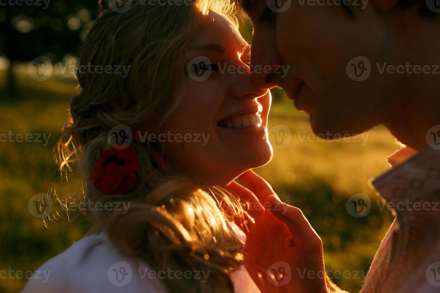 Couple kissing on the sunset photo