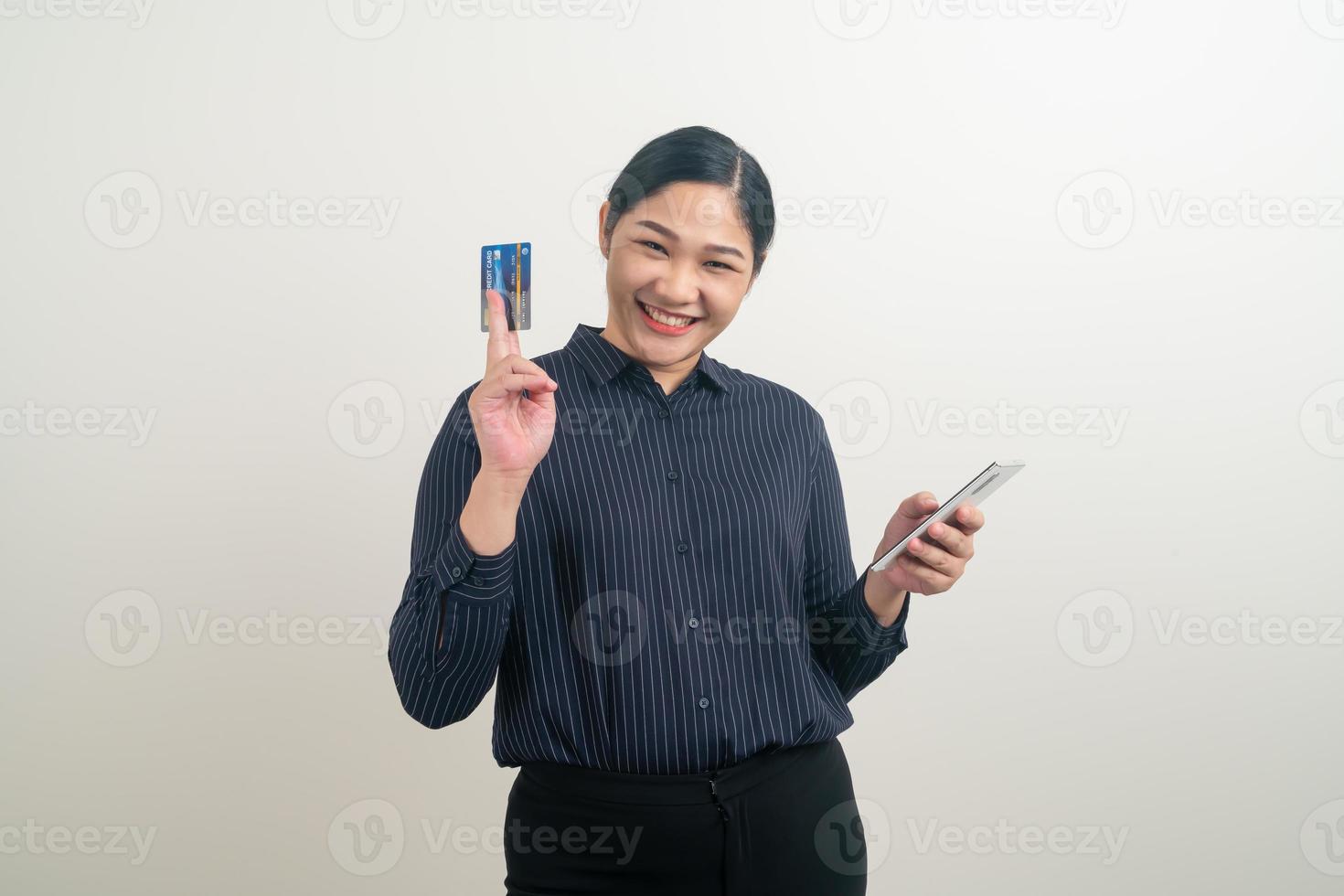 Asian woman using smartphone with hand holding credit card photo