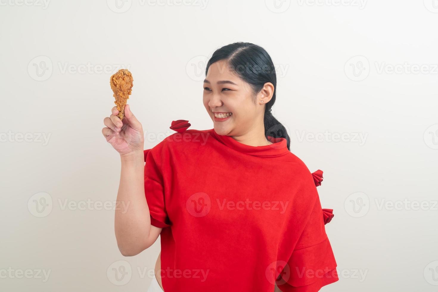 Asian woman with fried chicken on hand photo