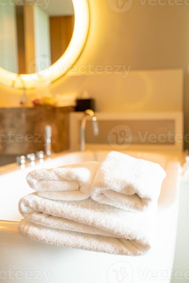 white towel on bath tub photo