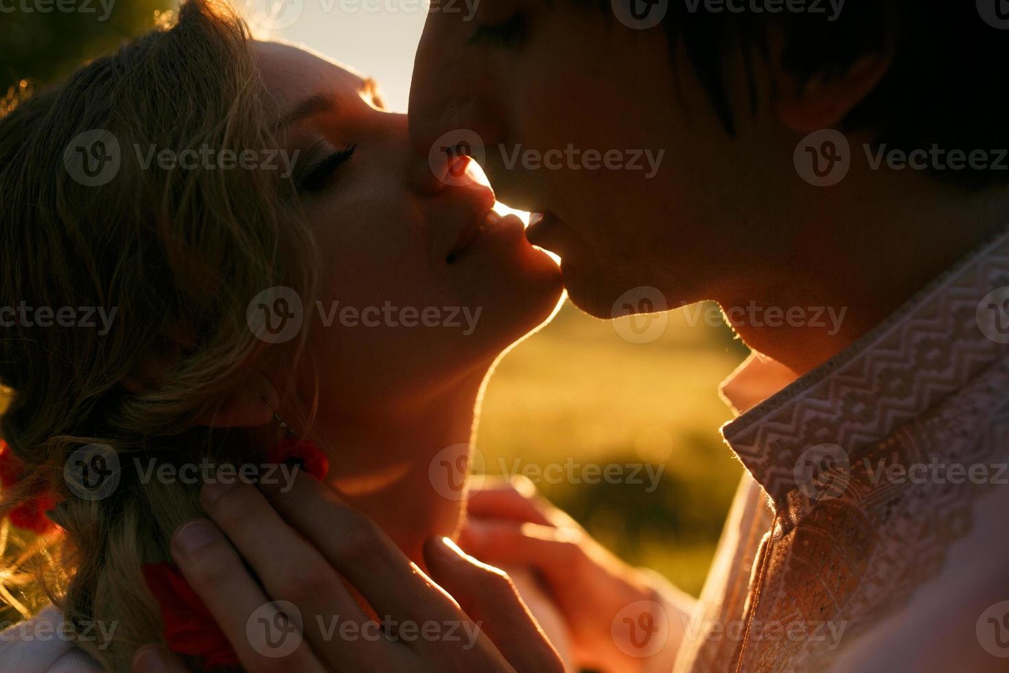 Couple kissing on the sunset photo