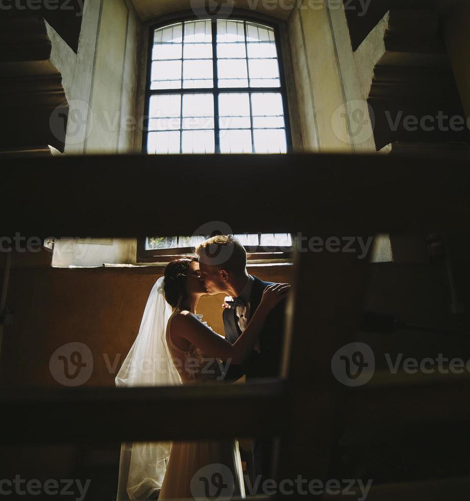 bride and groom on the background of a window. photo