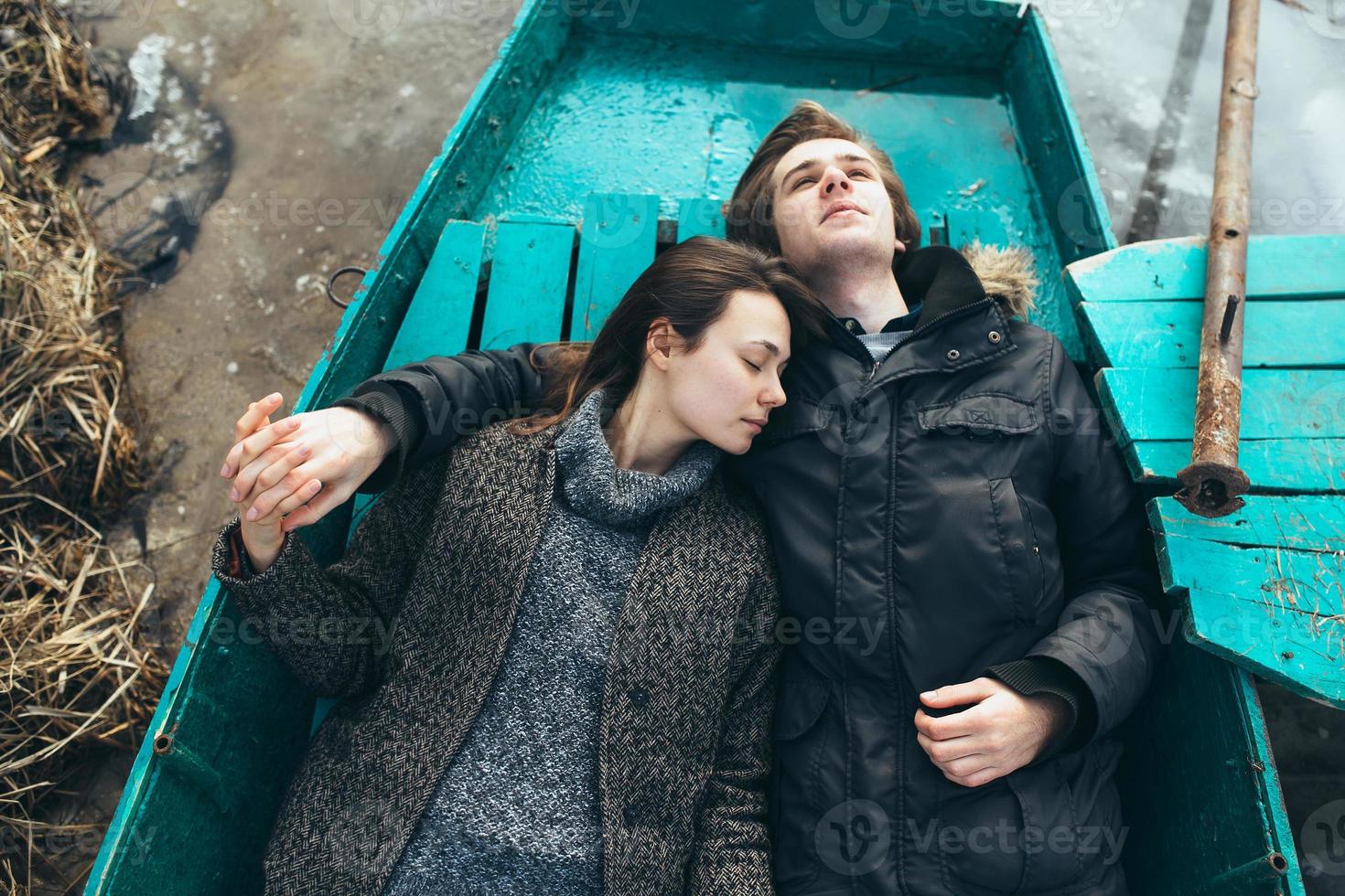 man and woman lie in the boat photo