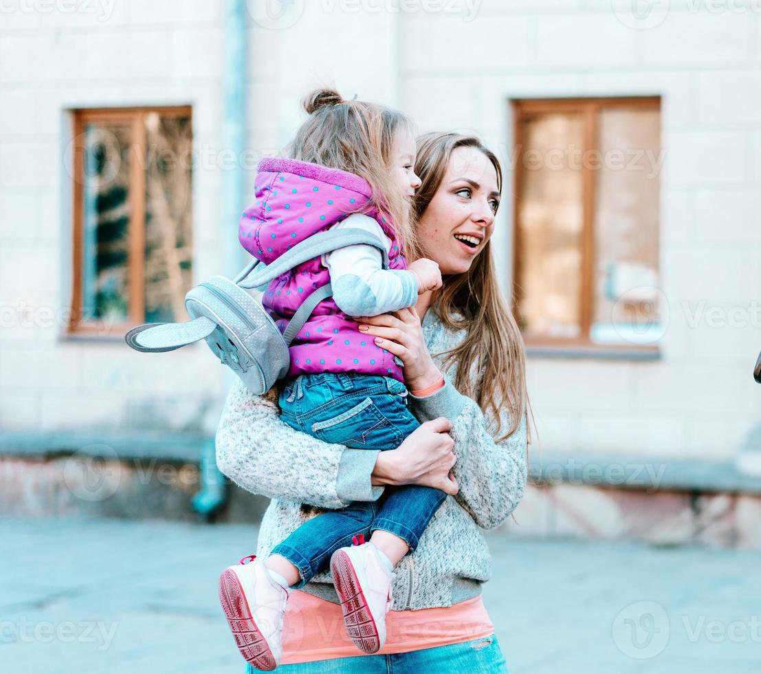 Mother holds a small daughter in her arms photo