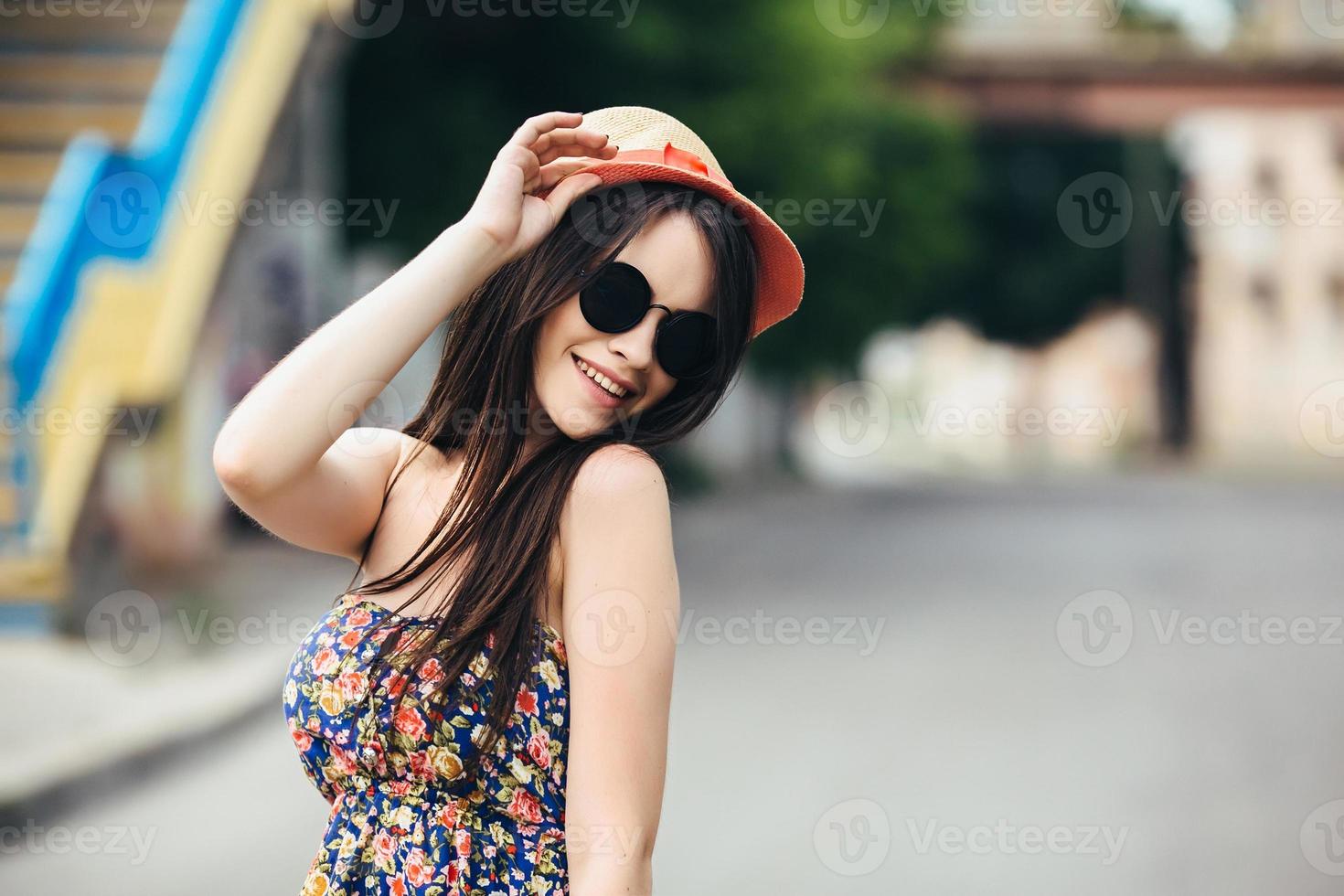 beautiful girl poses for camera in the city photo