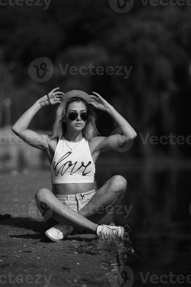 beautiful girl sitting on the pier photo
