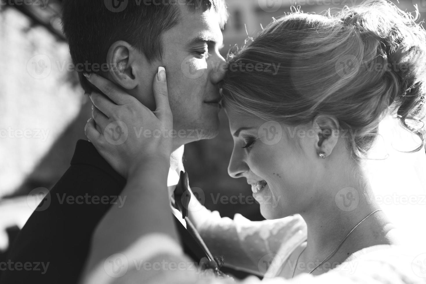 bride and groom posing on the streets photo