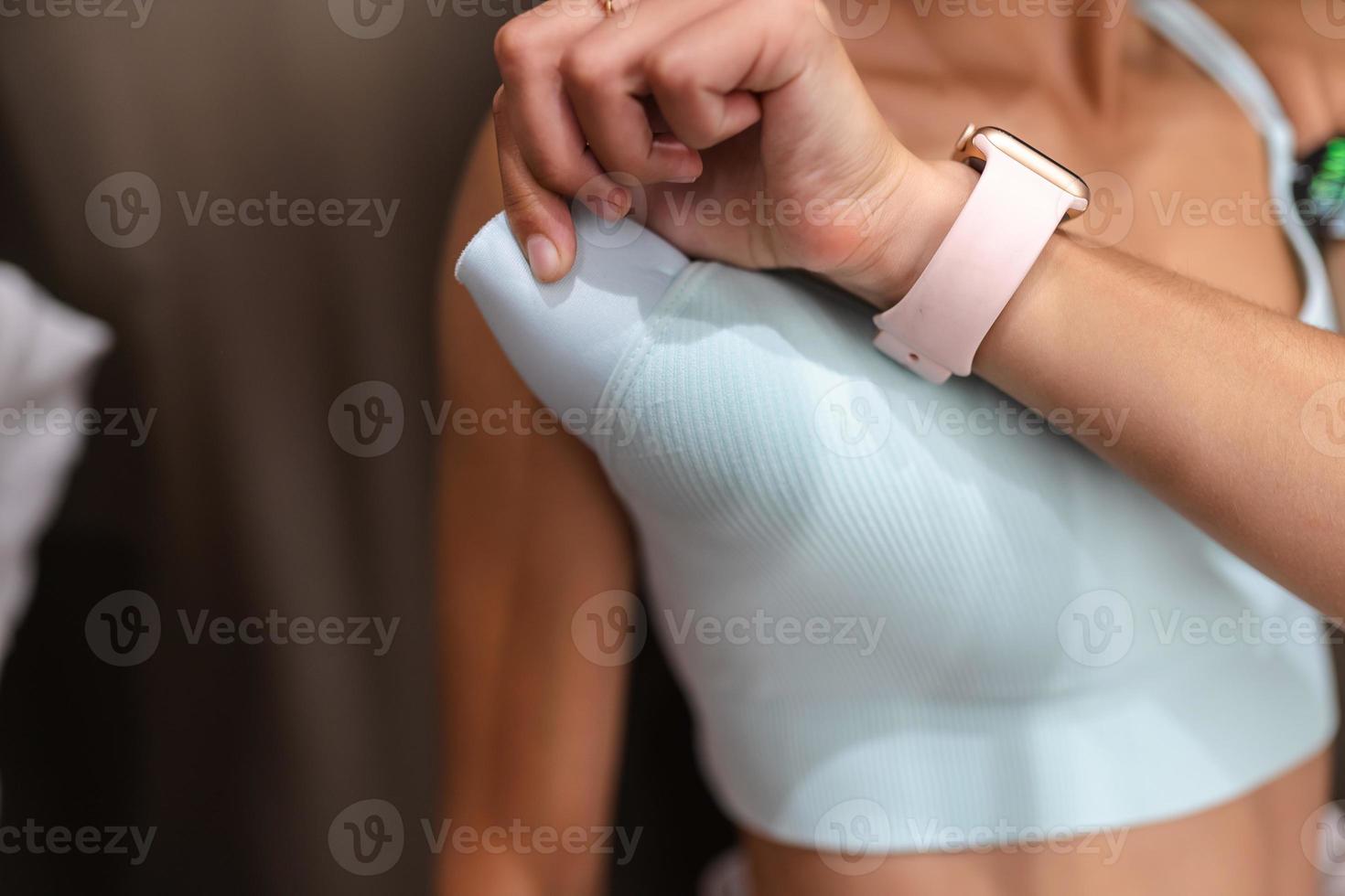 Woman hand pull out bra pad from brassiere photo