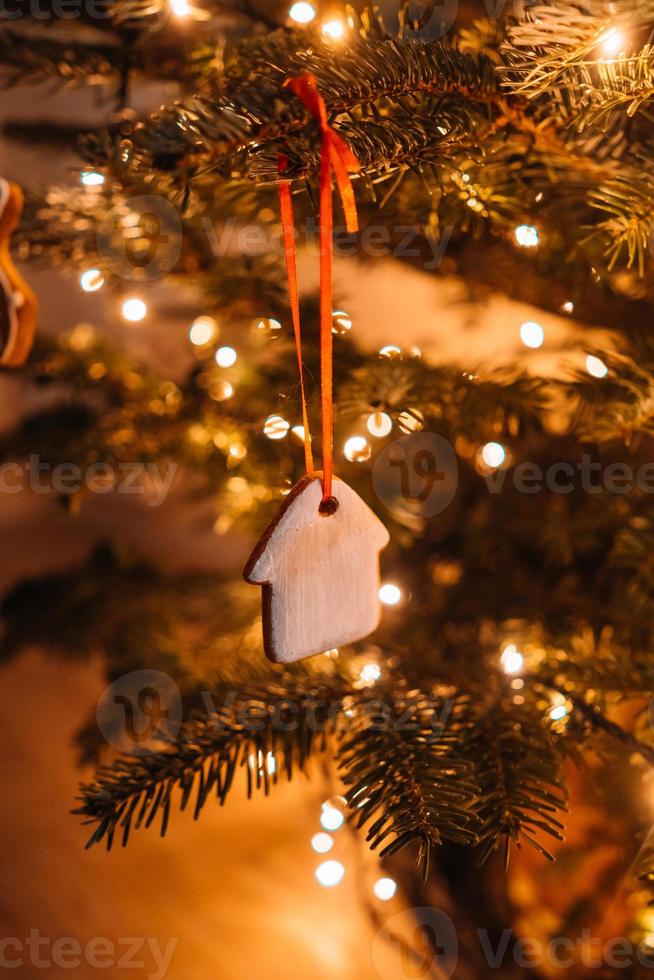 Christmas tree decorated with gingerbread cookies and garland photo