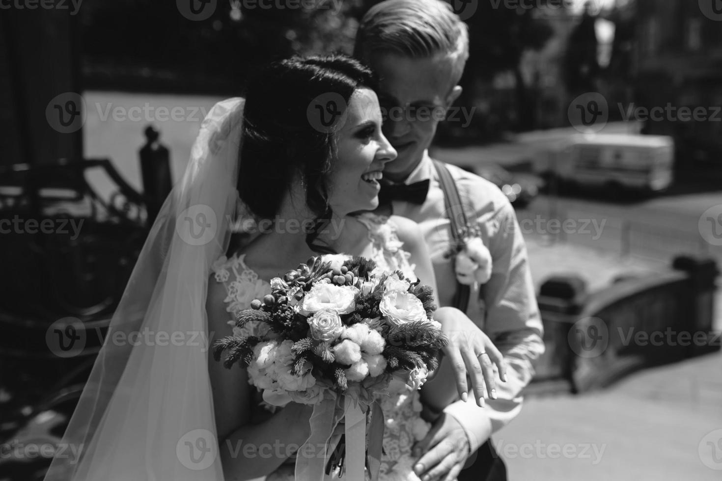 bride and groom posing on the streets photo