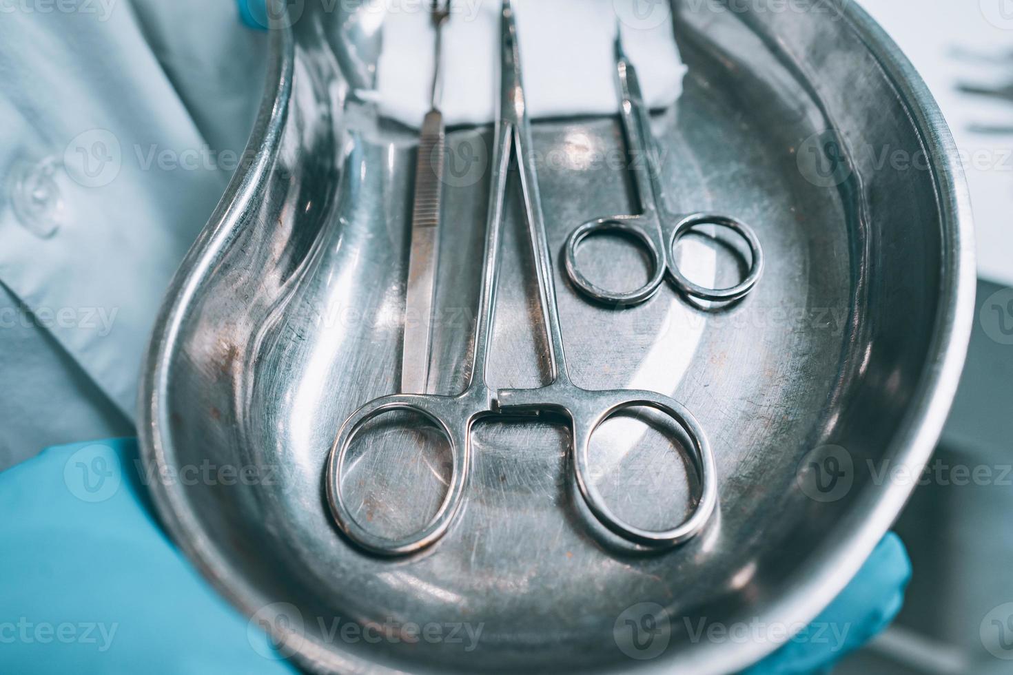 Several surgical instruments lie on a tray photo