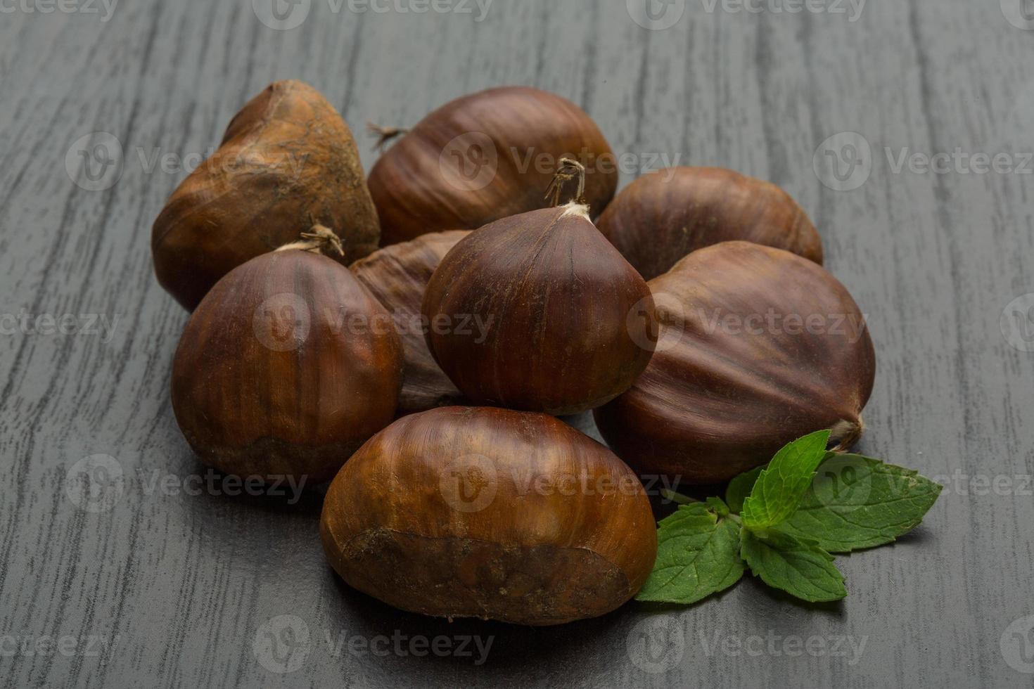 Chestnut on wooden background photo