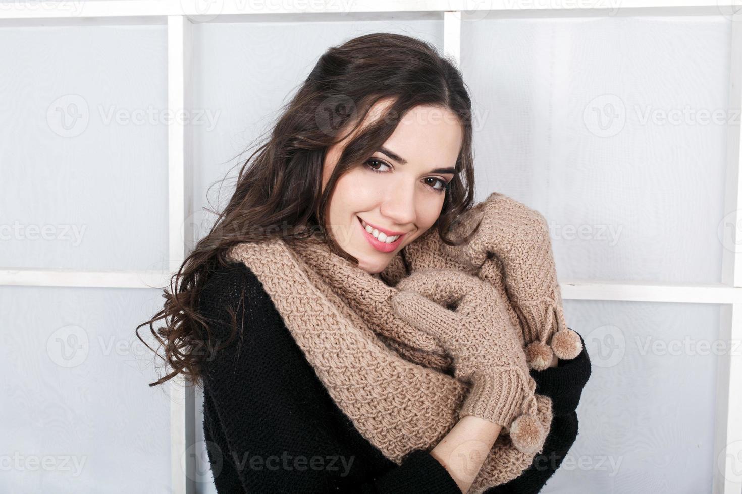 Cute girl in winter outfit posing for the camera. Christmas background photo