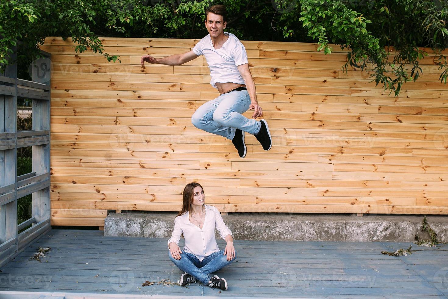 couple posing on a background of the wooden wall photo