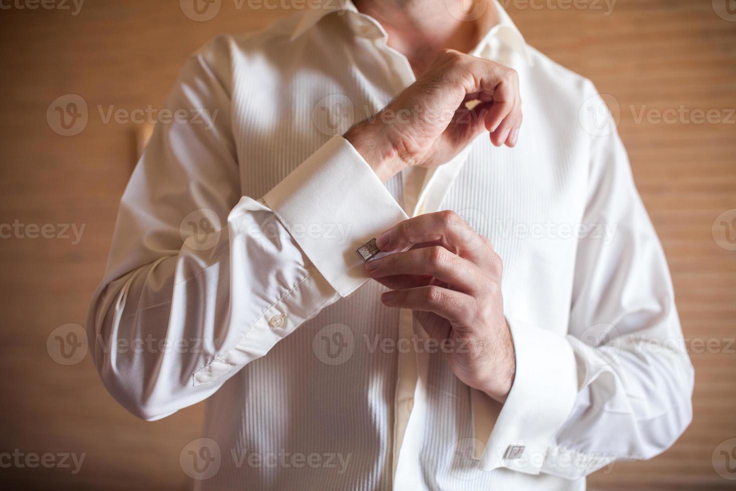 Groom prepares for wedding photo