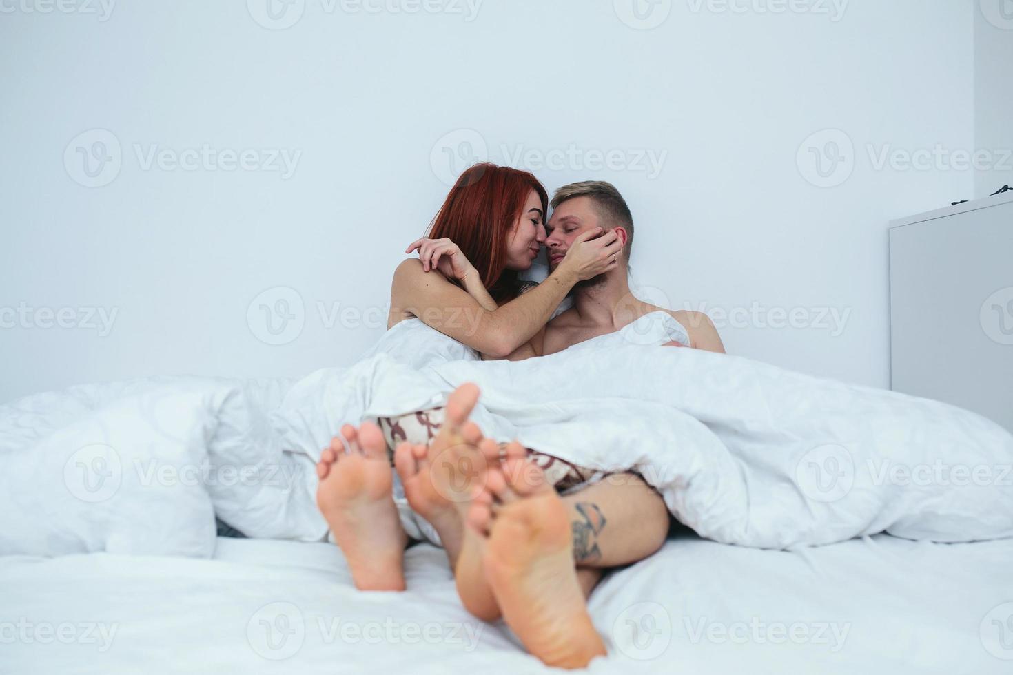 Young couple in bed together photo