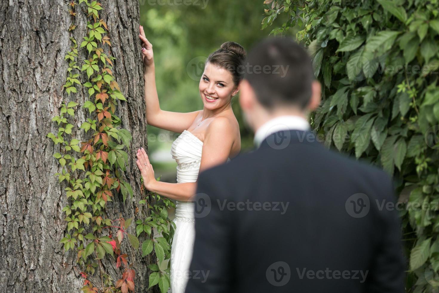 Beautiful wedding couple standing opposite each other photo