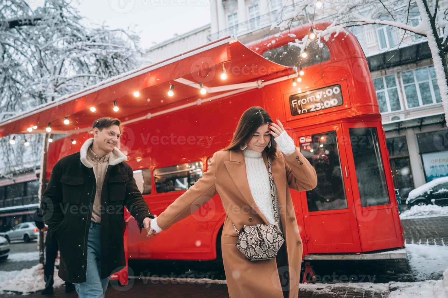 beautiful young couple walking down the street photo