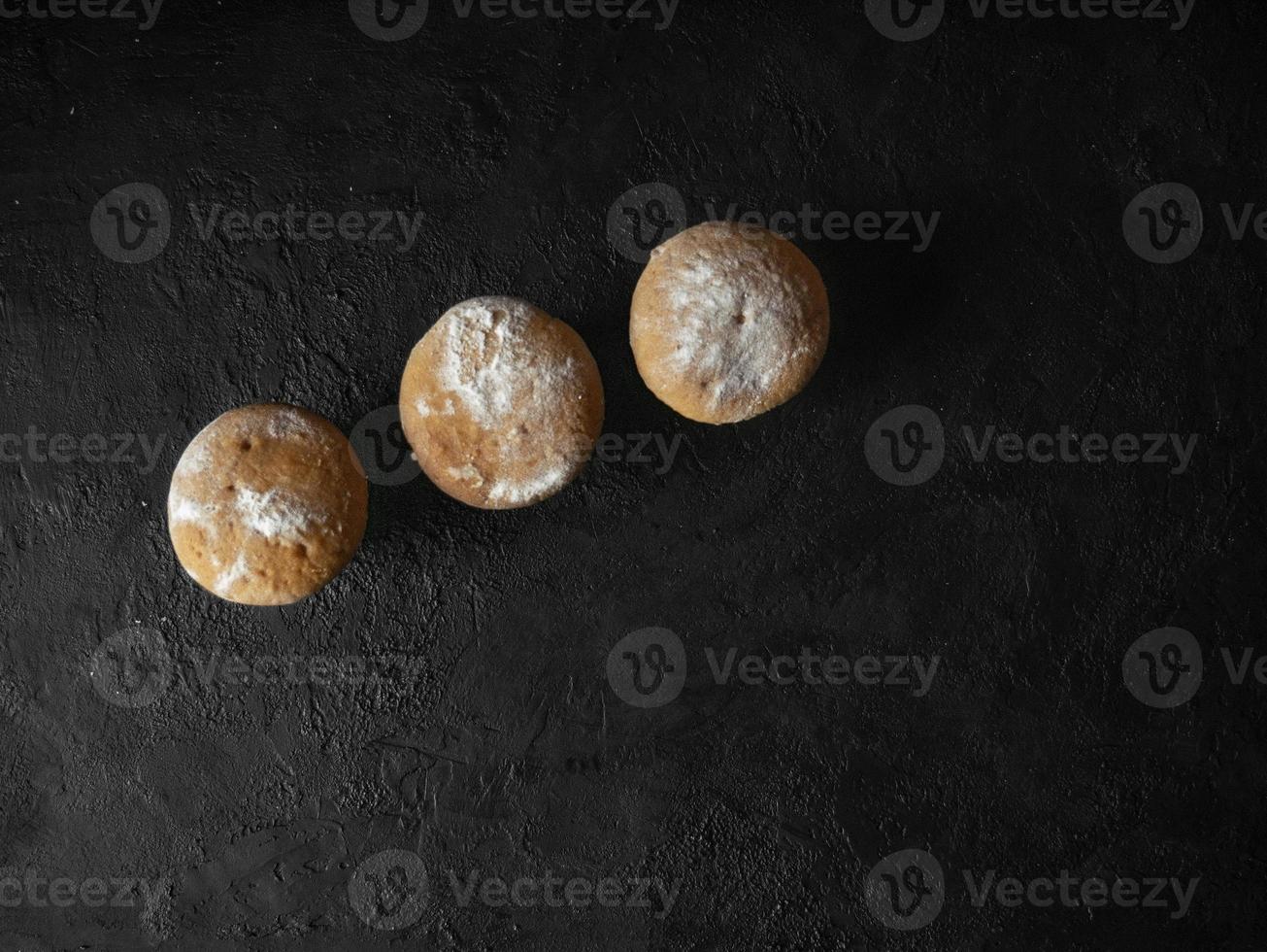 Cakes on a dark stone background photo