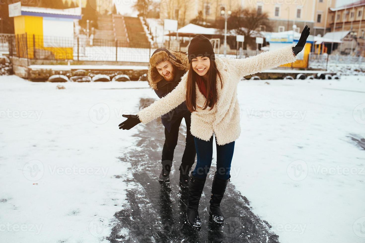 man and woman skate on ice photo