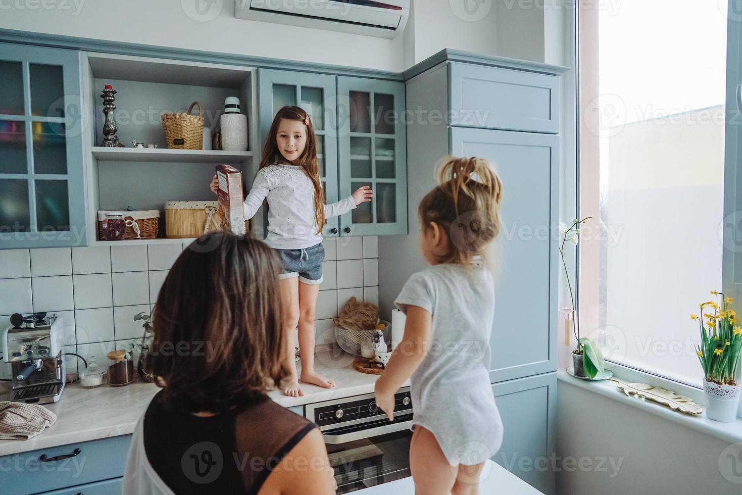 Happy family having fun in the kitchen photo