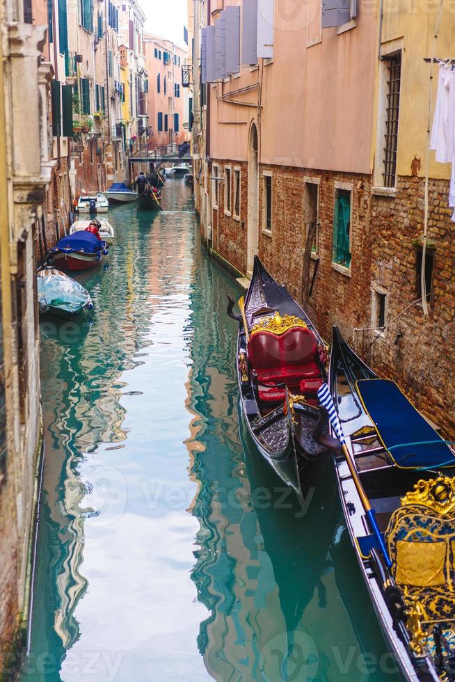 Venetian channel with ancient houses and boats photo