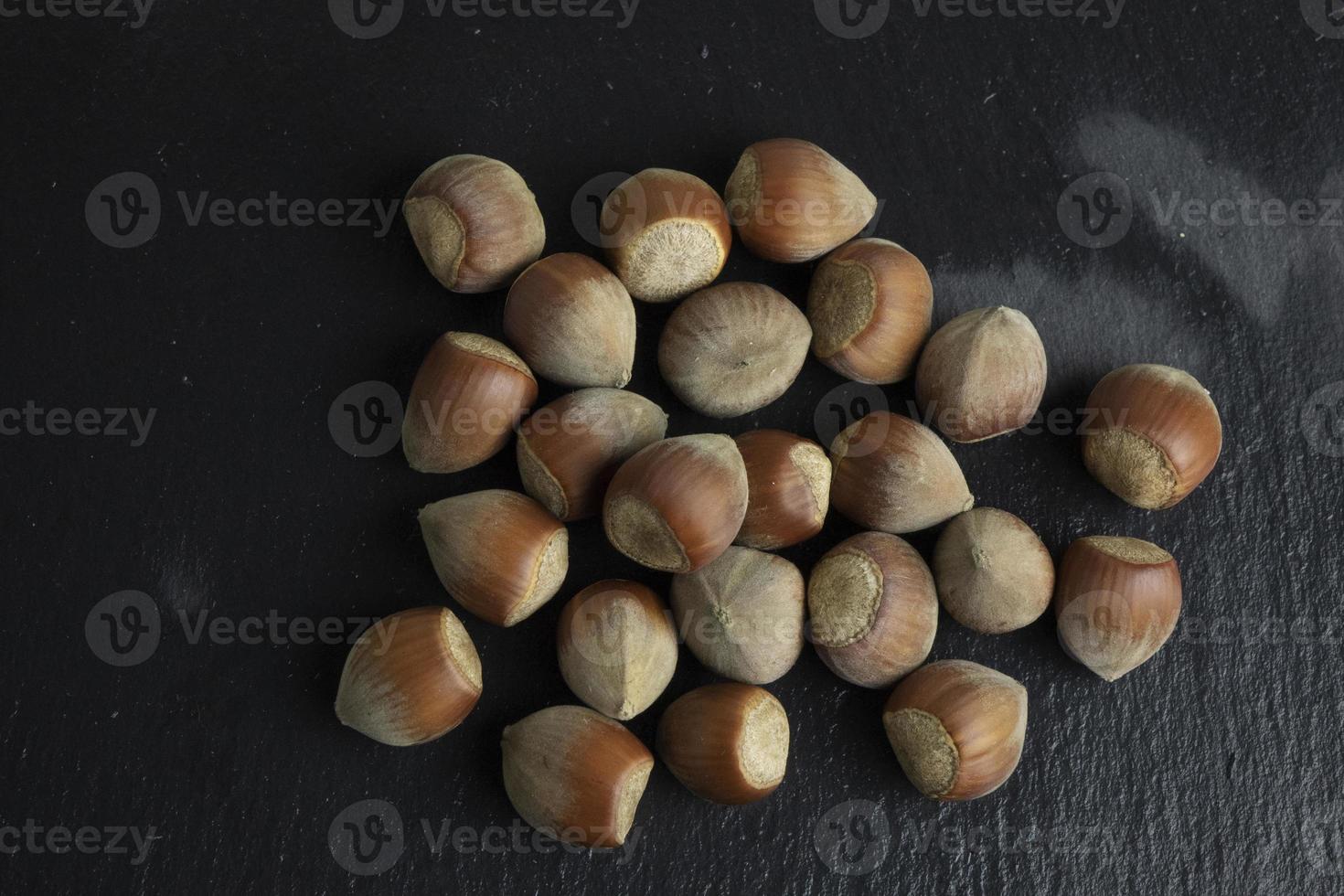 Hazelnut nut isolated on black stone background photo