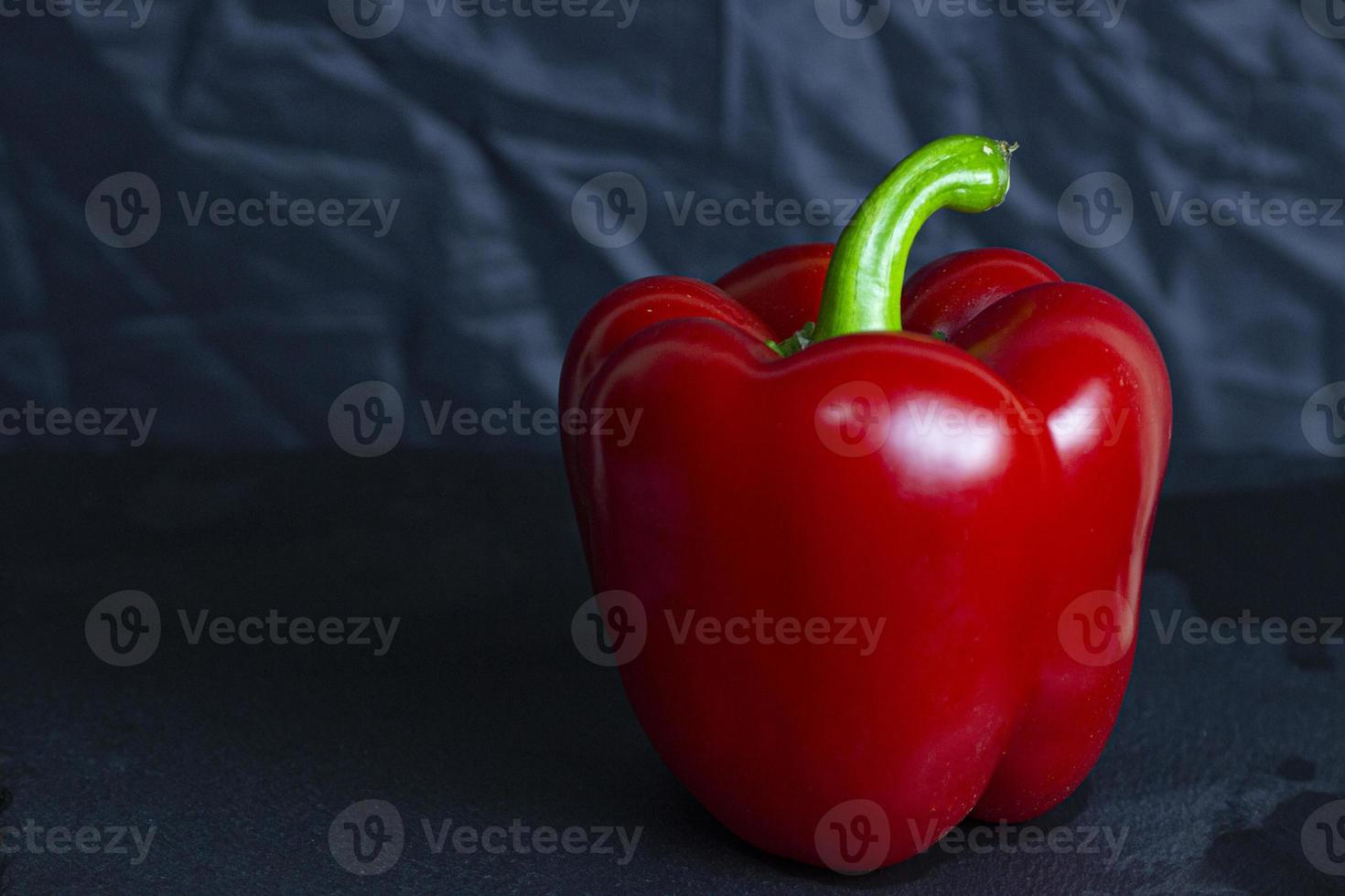 Fresh red sweet bulgarian pepper isolated on black background photo