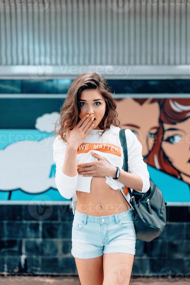 Beautiful young girl posing on metro station photo