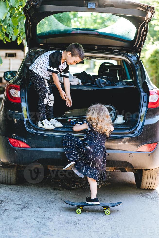 Boy and girl playing in the car photo