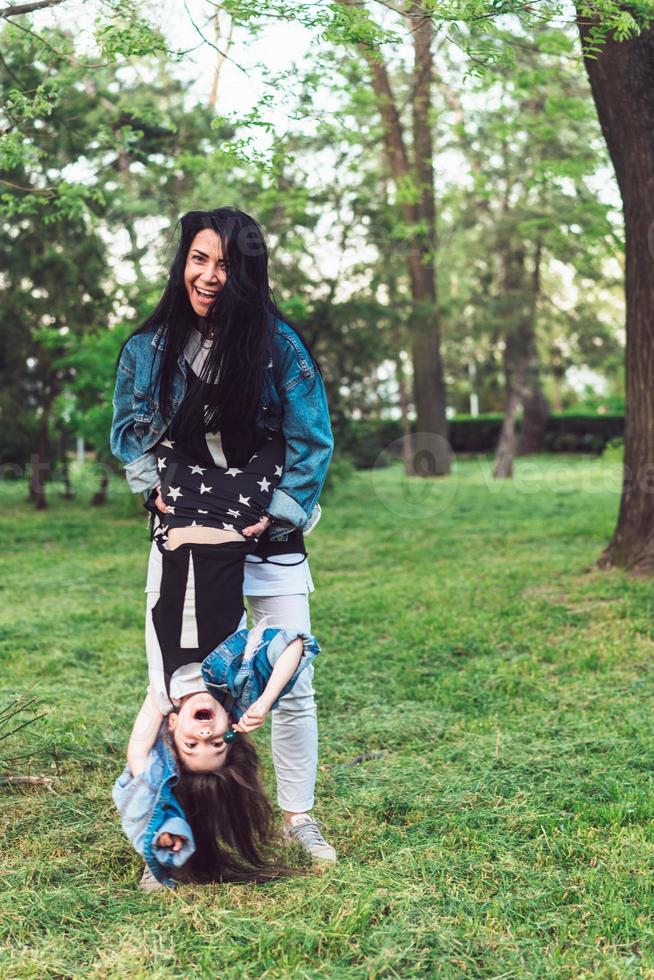 mom and daughter on the lawn have fun photo