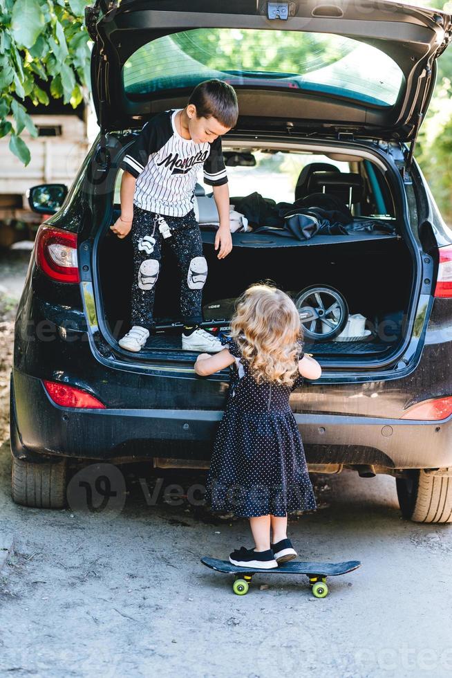 Boy and girl playing in the car photo