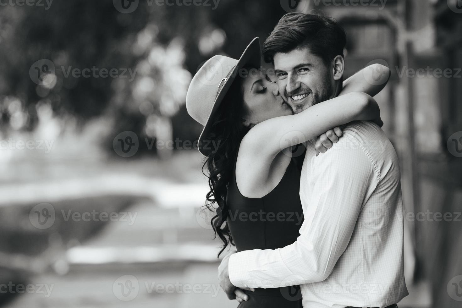 beautiful girl embraces and kisses her boyfriend photo