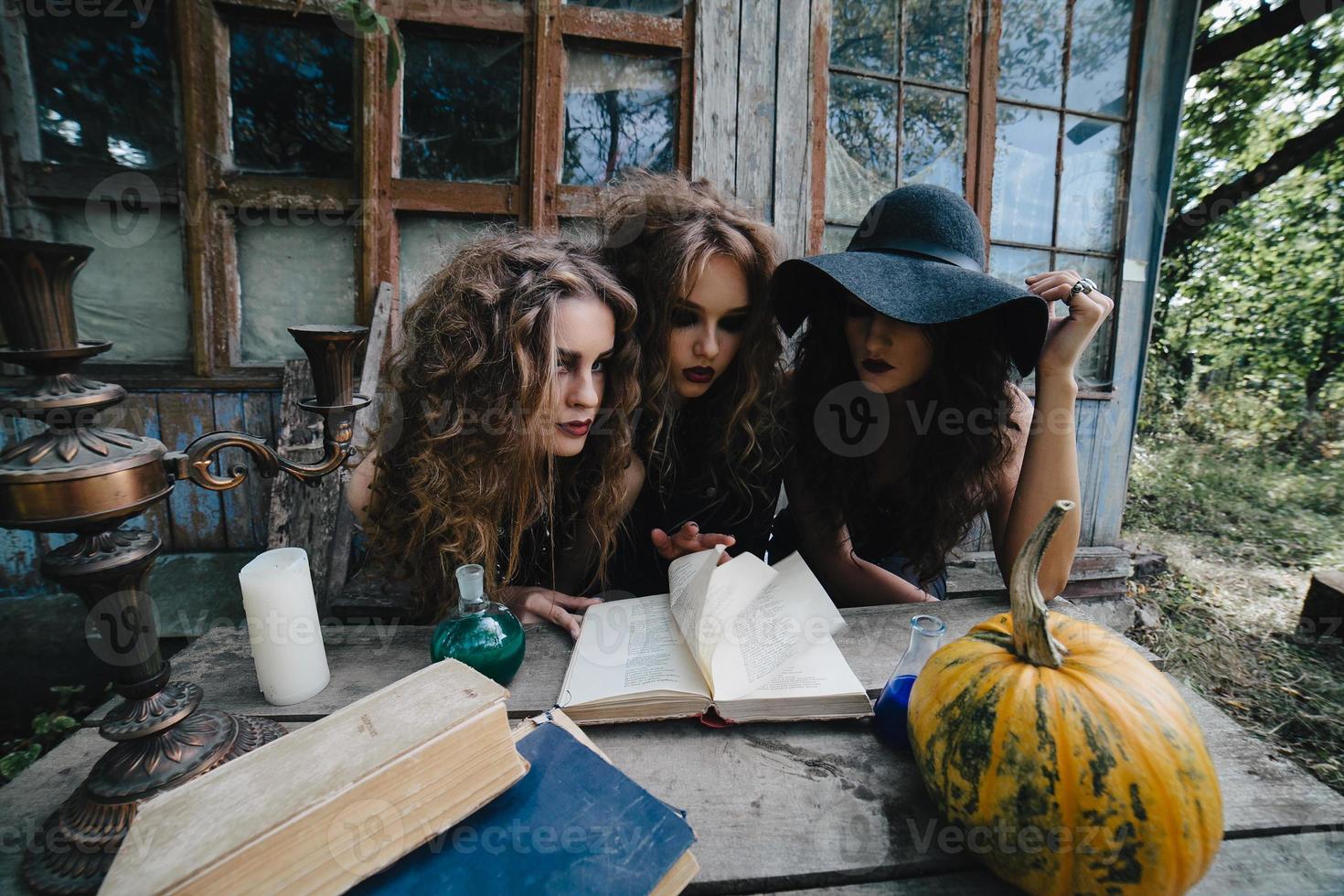 Three vintage witches perform magic ritual photo