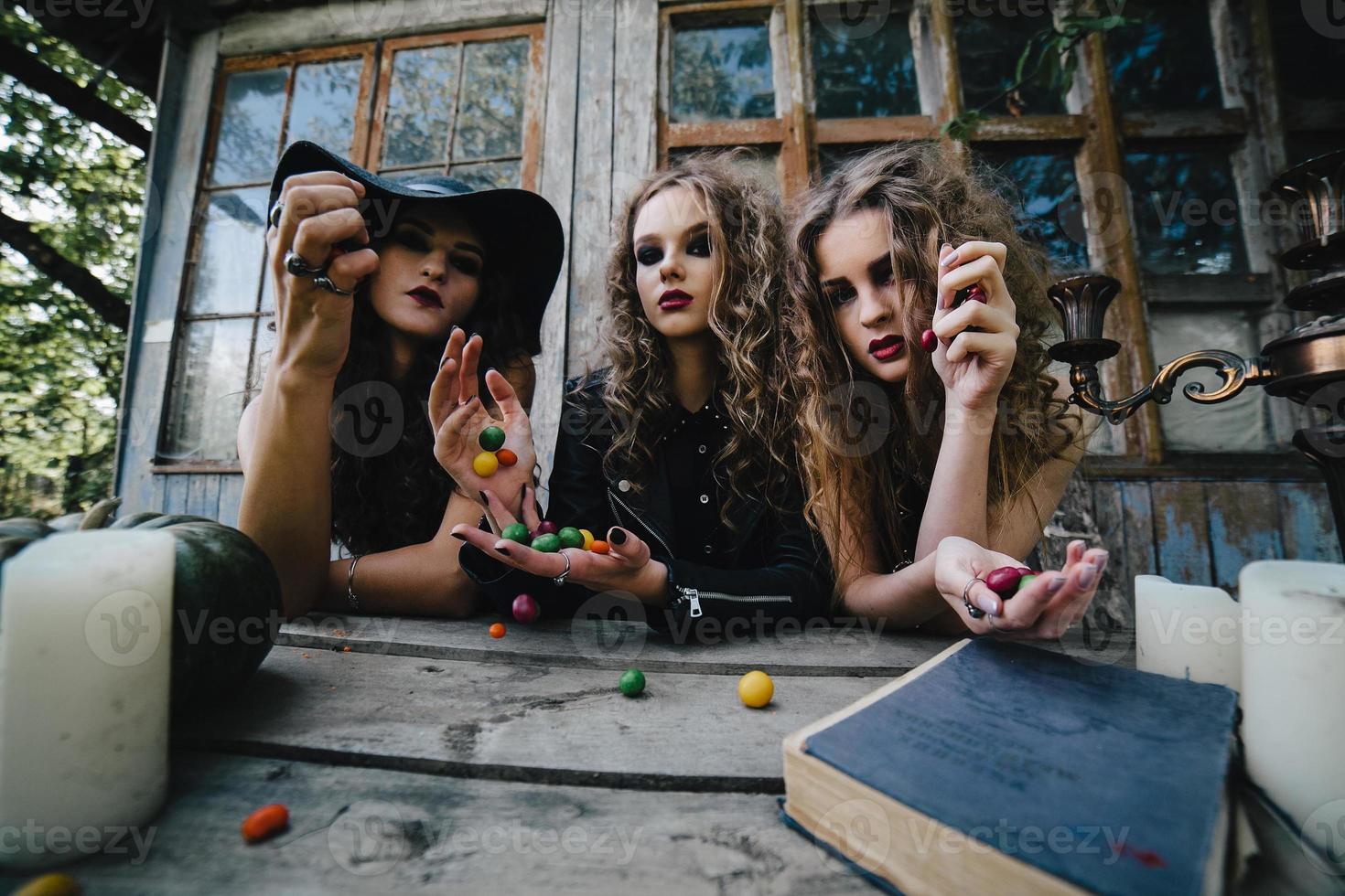 Three vintage witches perform magic ritual photo