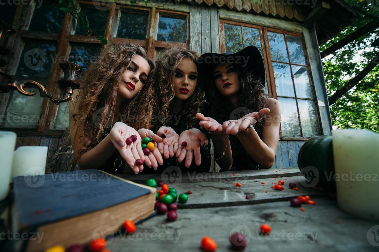 Three vintage witches perform magic ritual photo