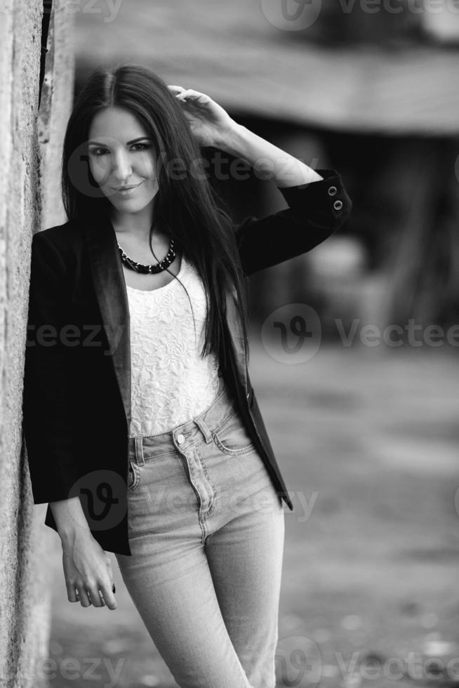 Beautiful female model posing against the wall photo