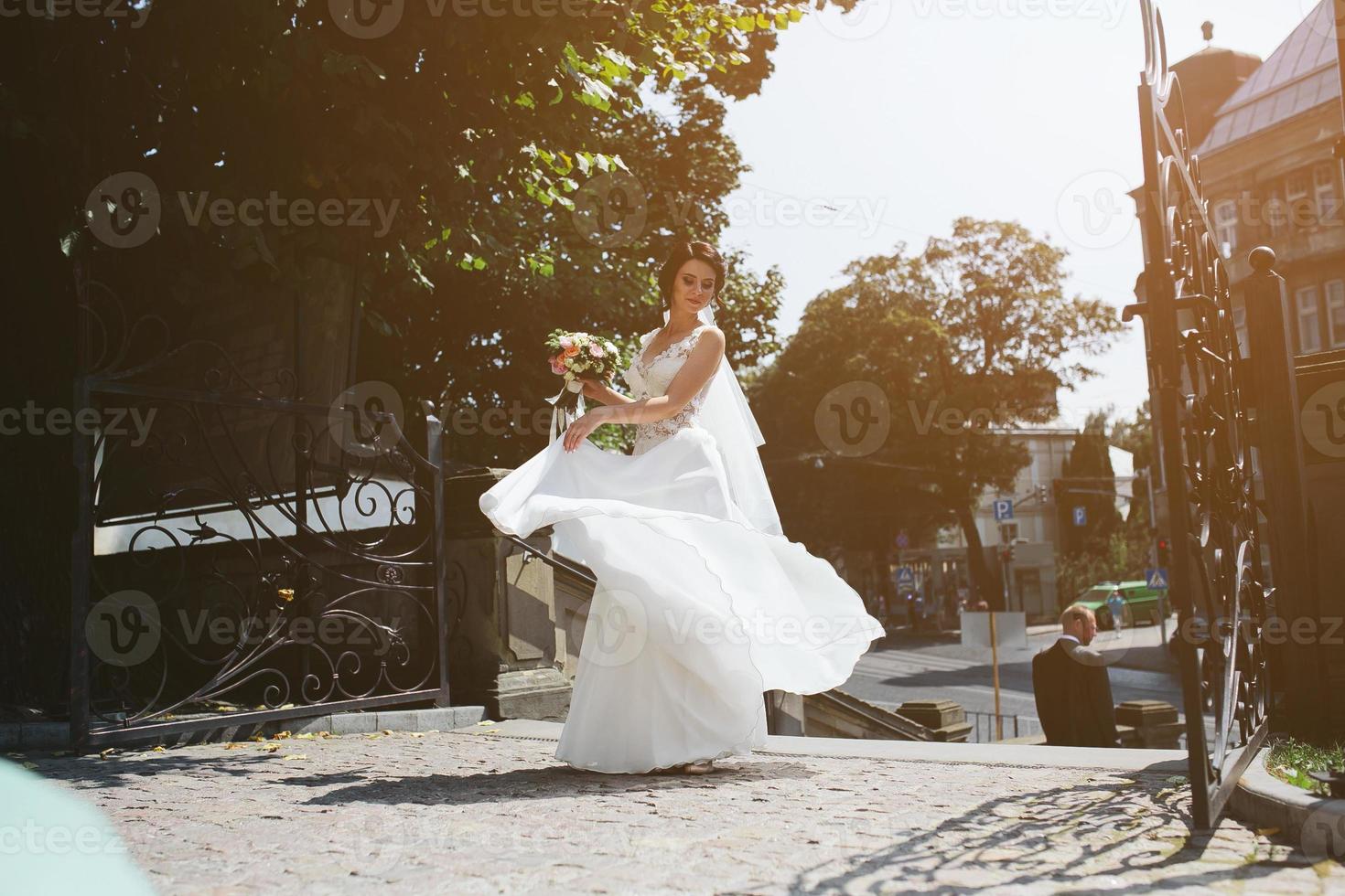 Bride posing in city photo