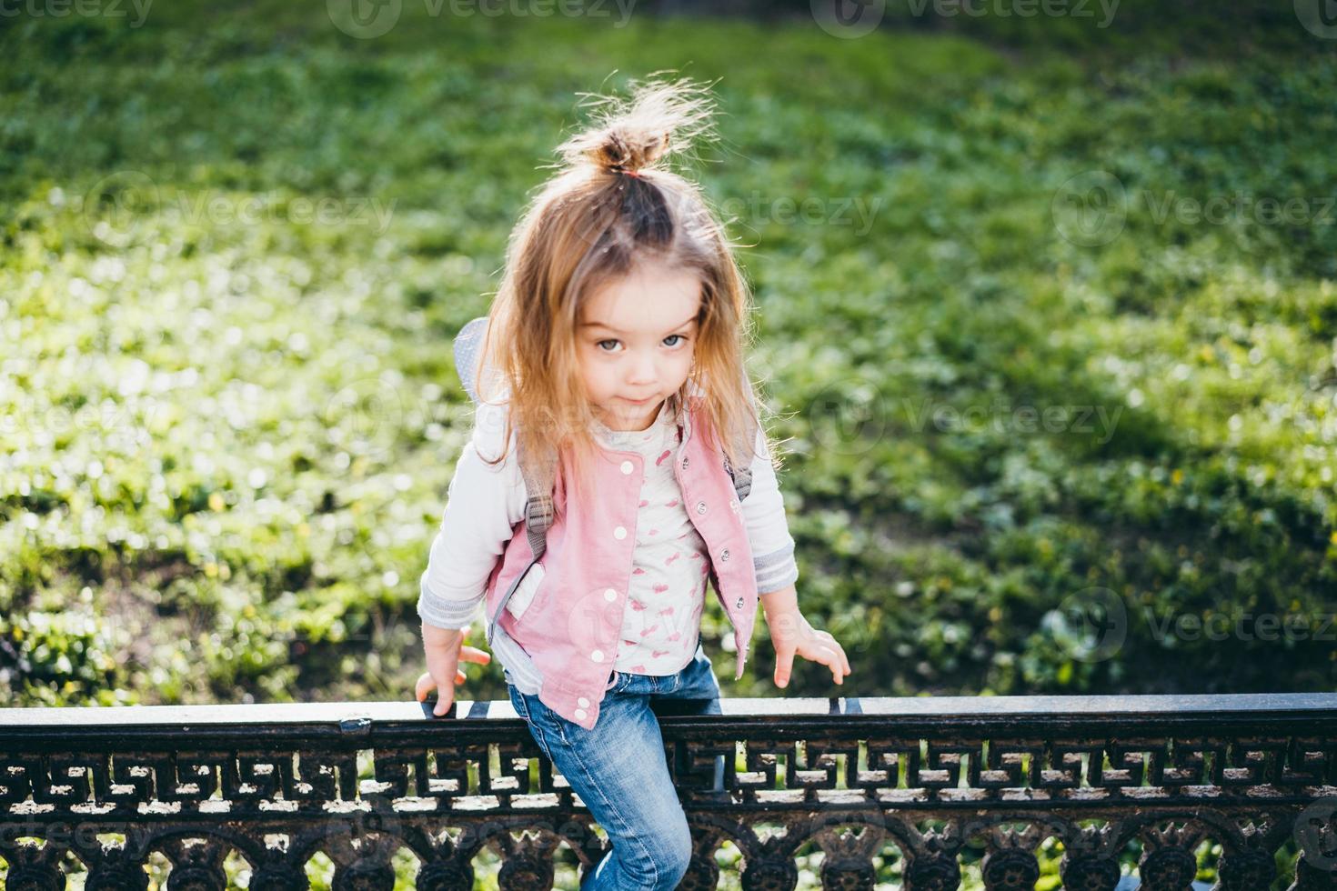 Little girl walking in the park photo