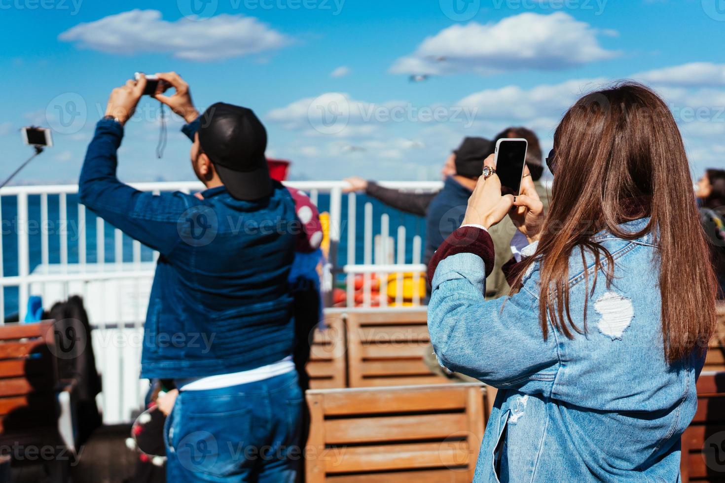 Man and woman take pictures of birds photo