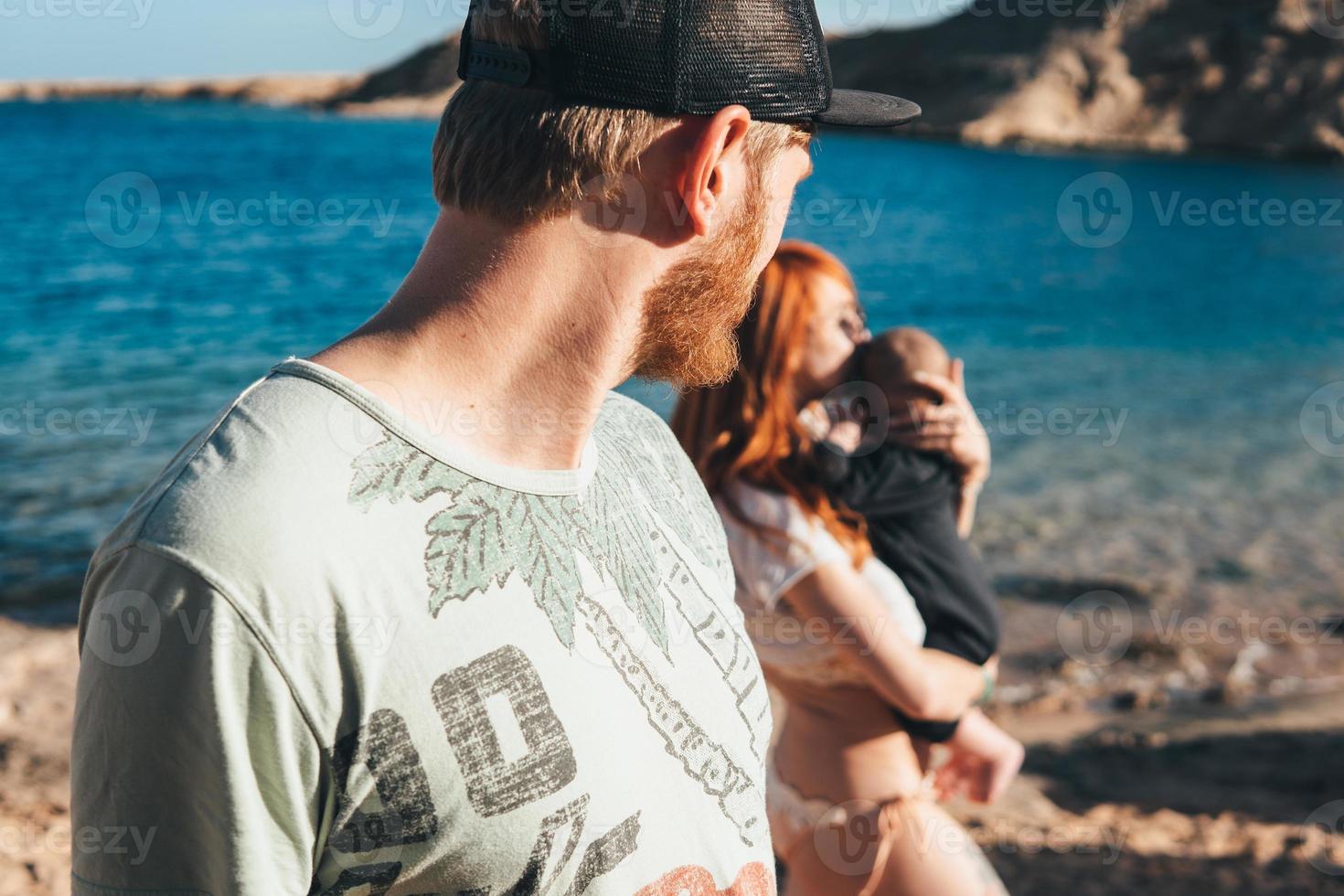 Dad, looks at mom with little son photo