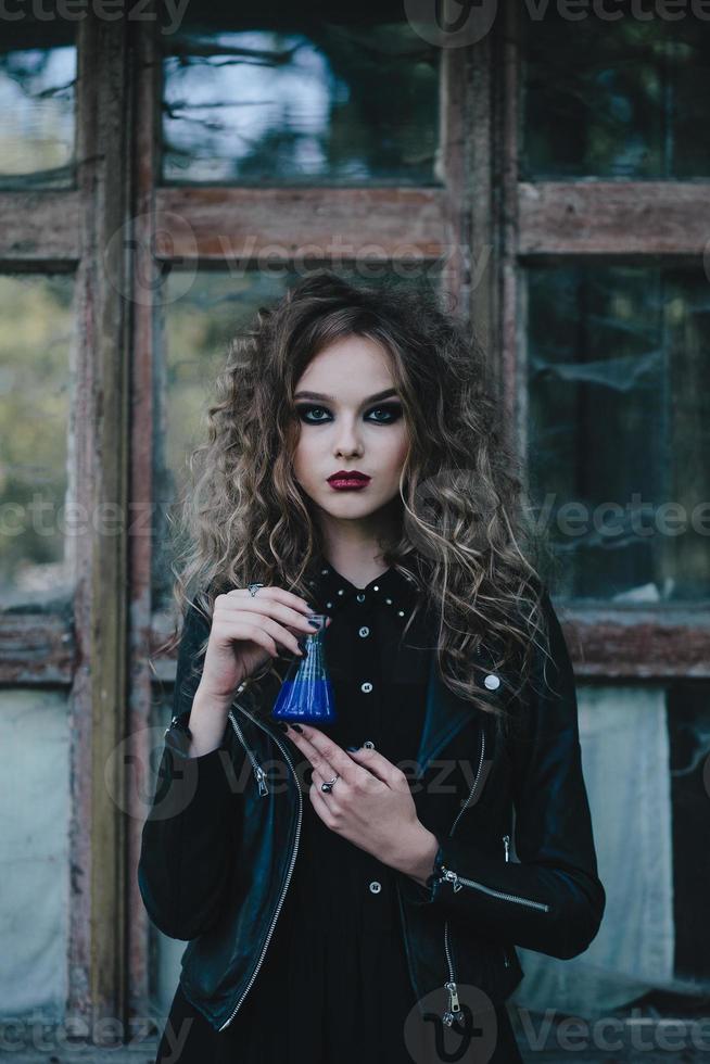 Vintage witch with elixir in hand photo