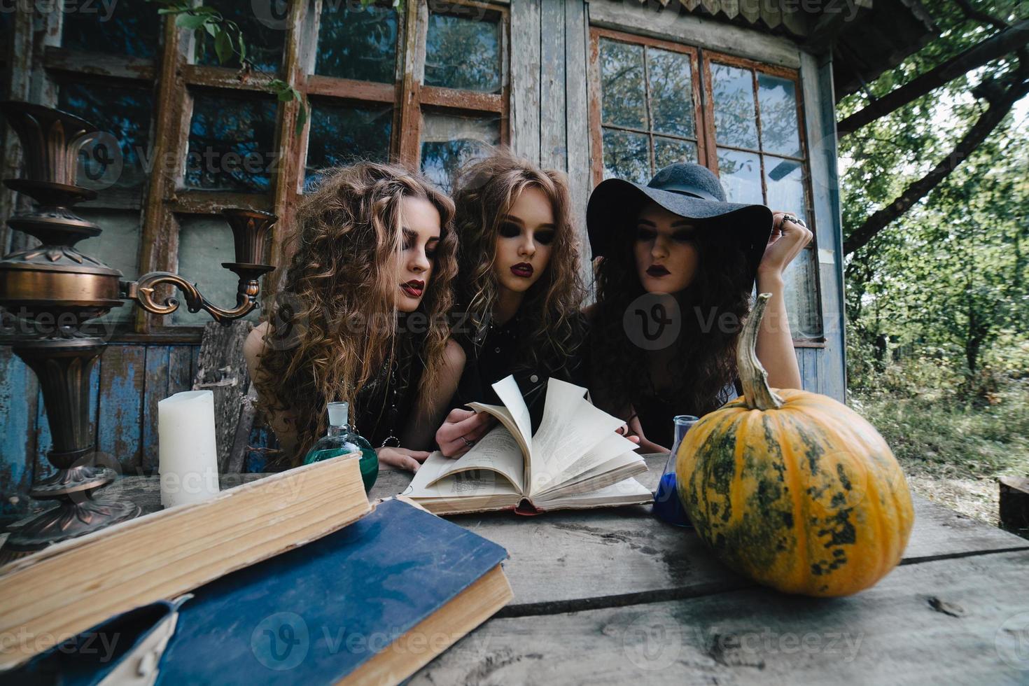 Three vintage witches perform magic ritual photo