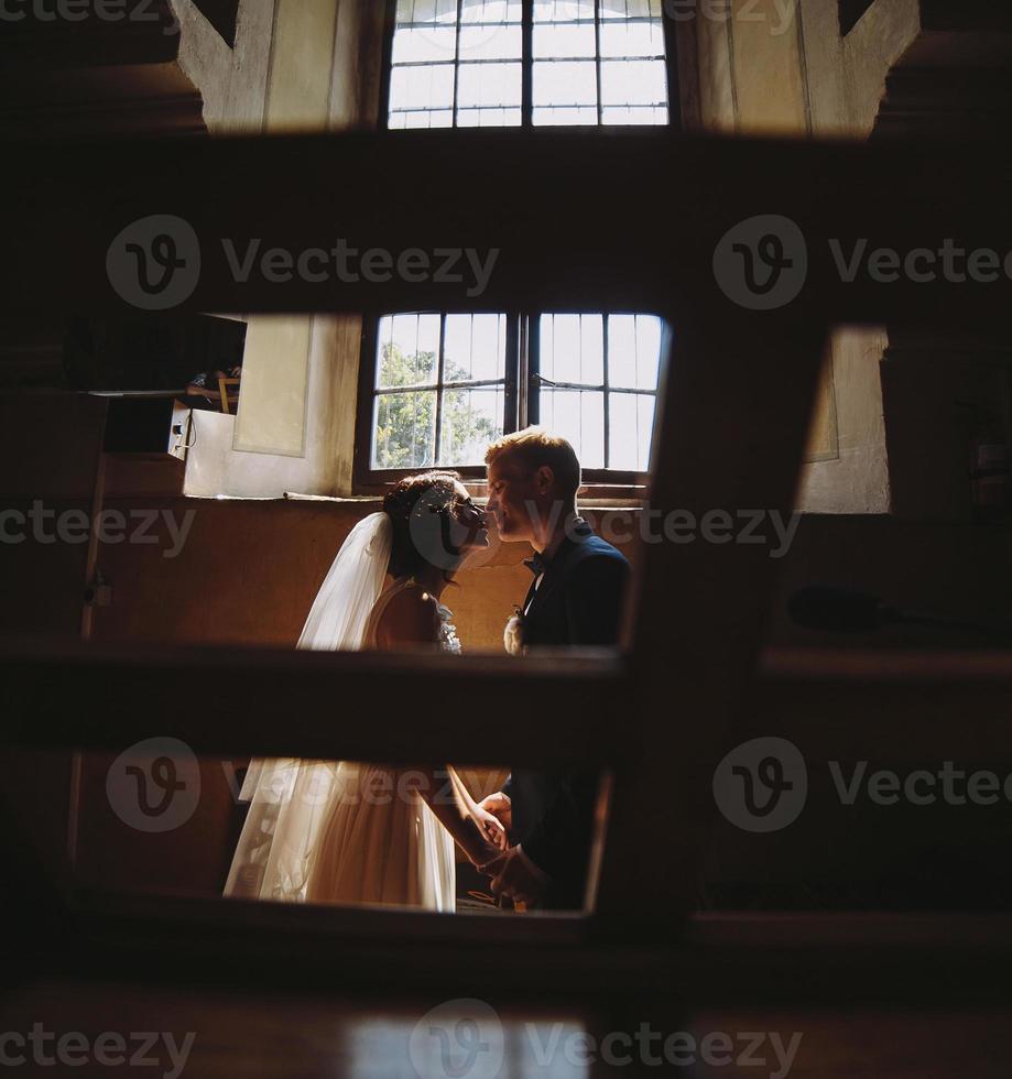 bride and groom on the background of a window. photo