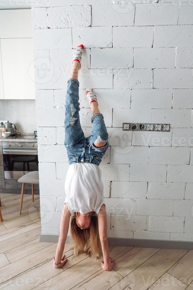 A woman is standing on his hands upside down photo