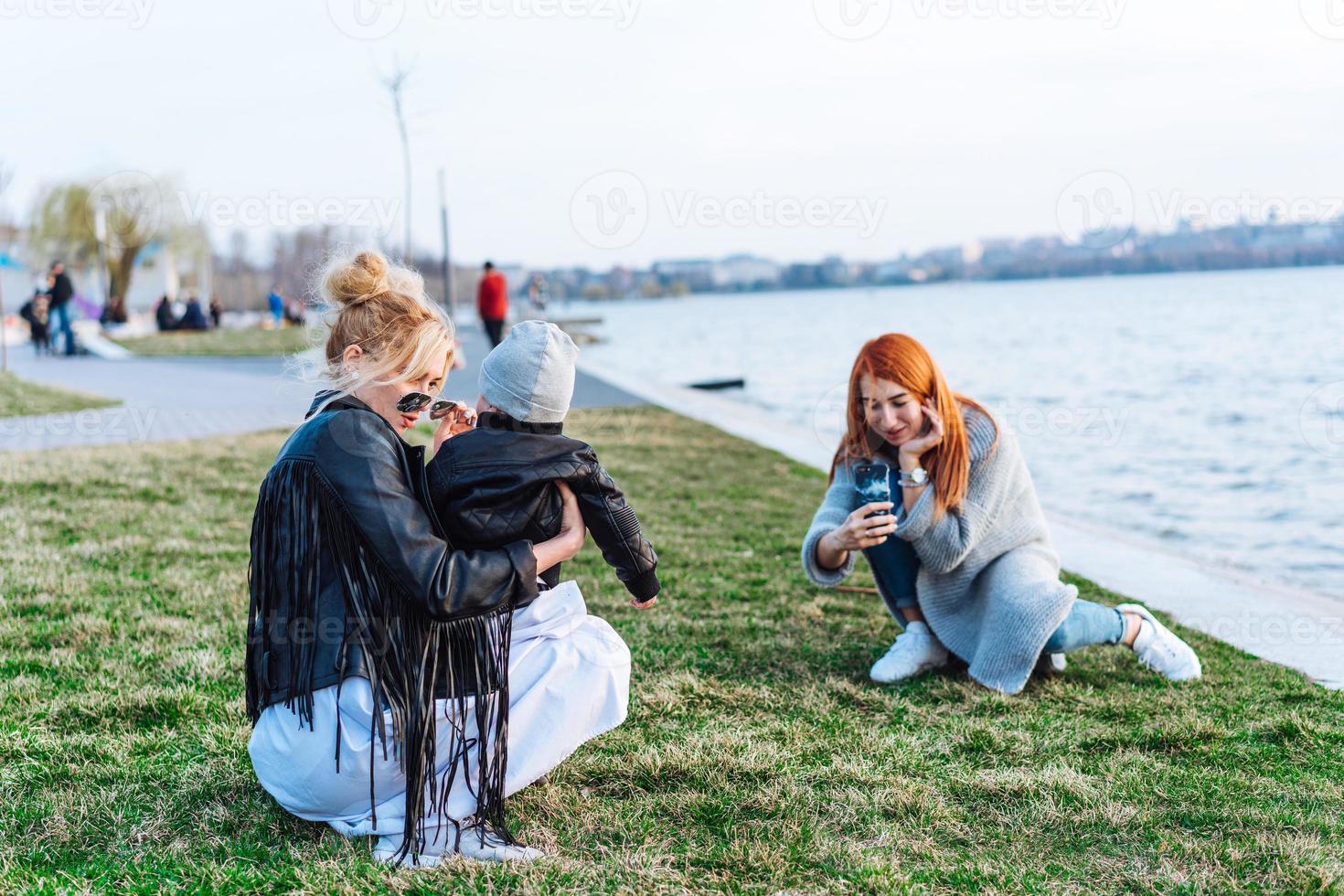 Two women and a little boy on the lake photo
