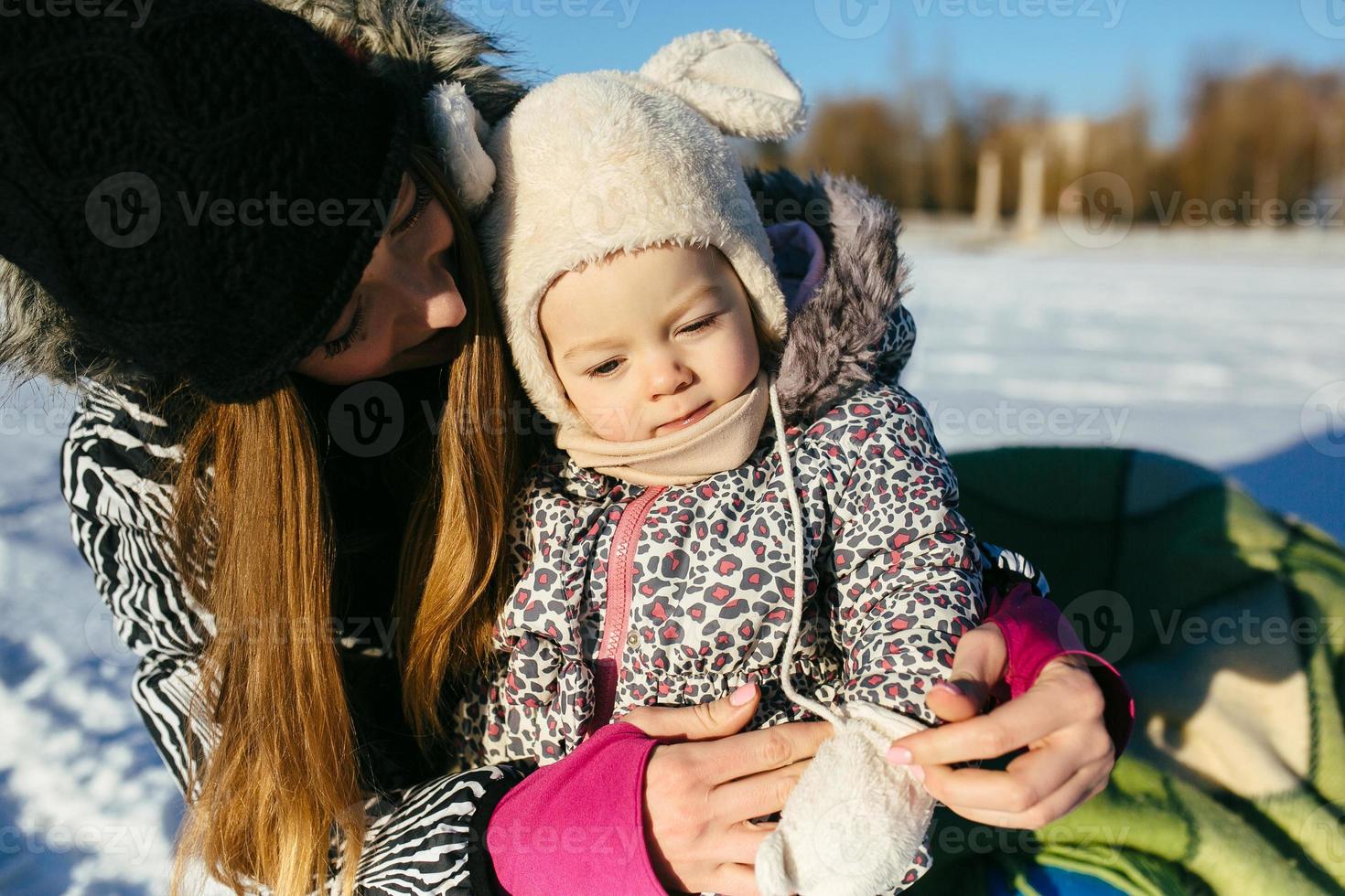 mother and daughter in winter outdoors photo